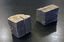 Sculptural geometric void carved into a historic Erfurt cobblestone, exemplifying concrete art.